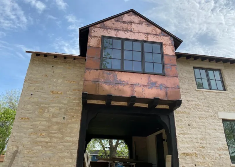 Copper metal panel facade on a stone building for Skylight Installation in Courtland